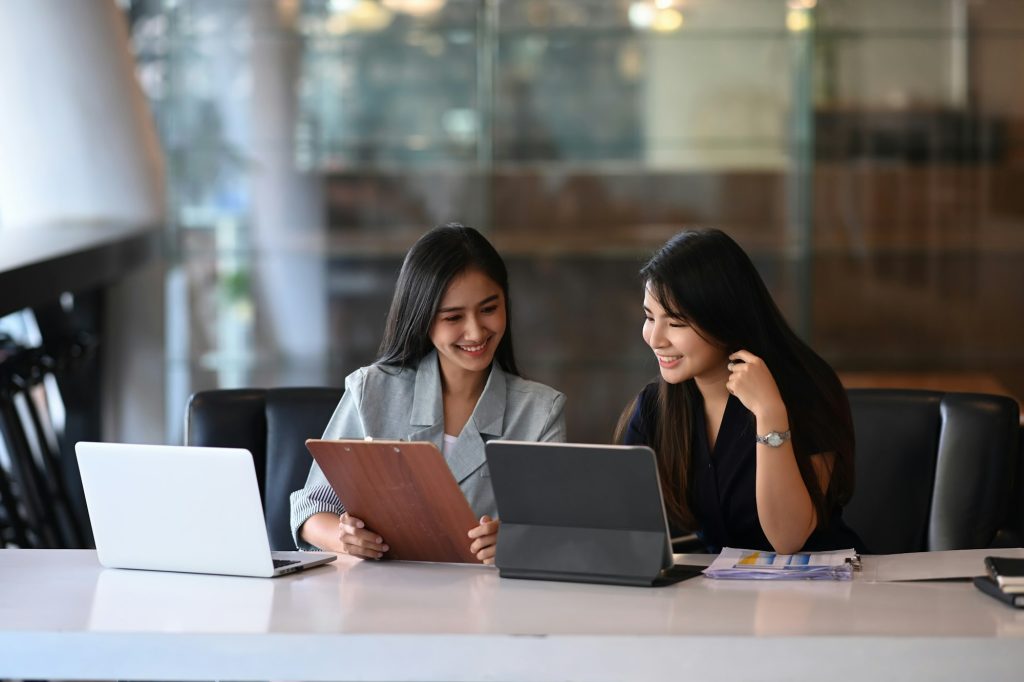 Two young businesswoman discussing new creative concept for the new product marketing promotion.